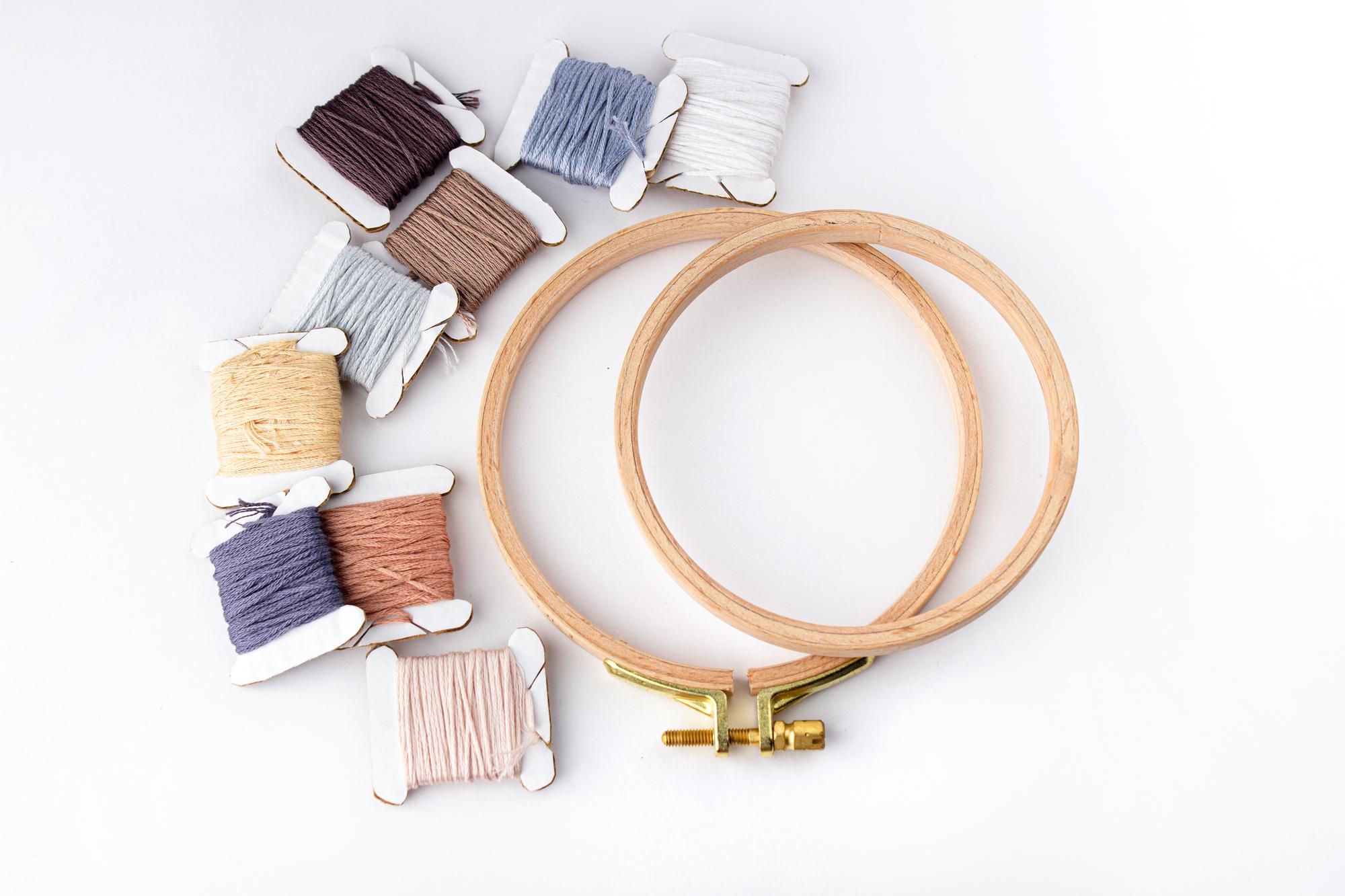 atelier workspace with embroidery hoops and threads